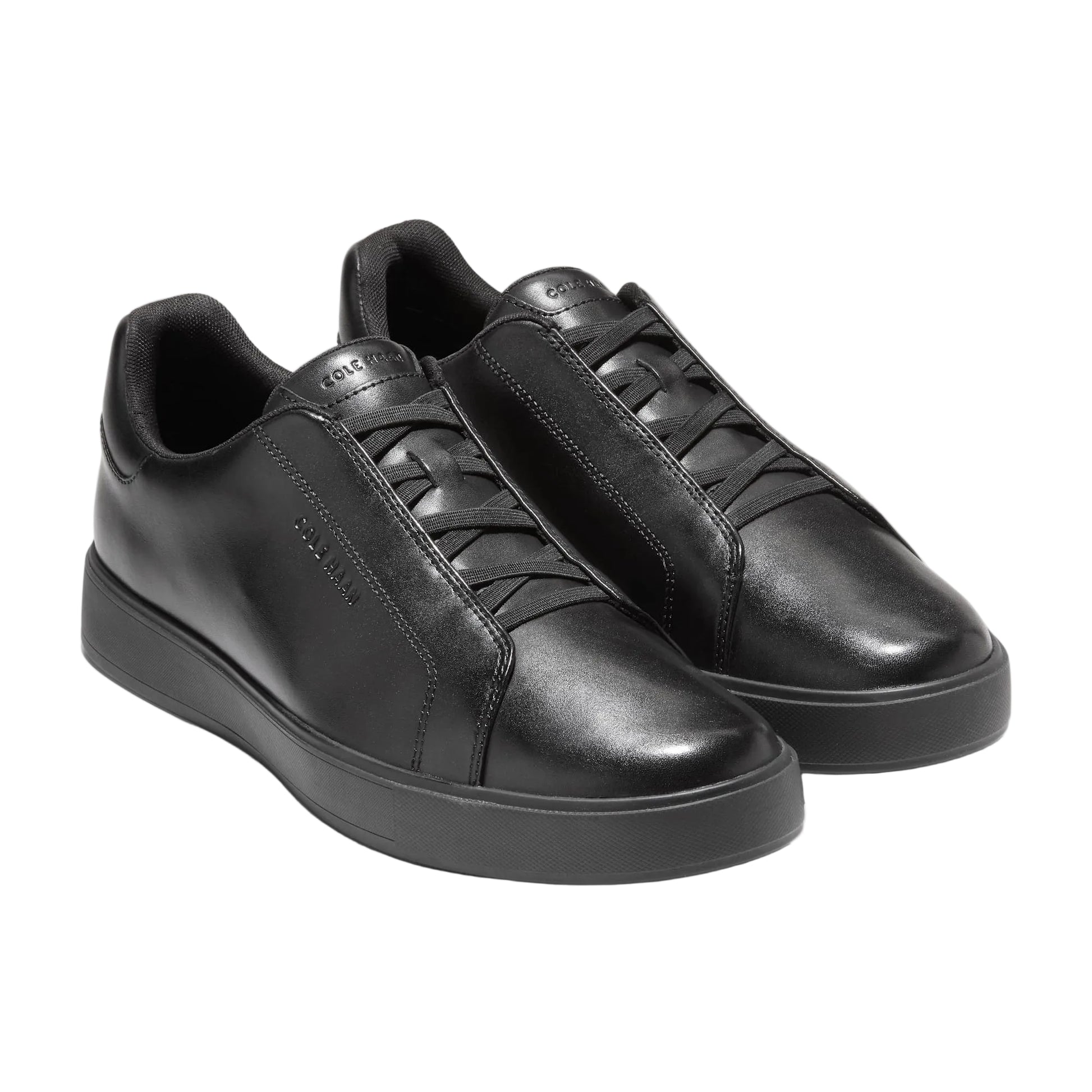 Pair of black leather sneakers on a white background